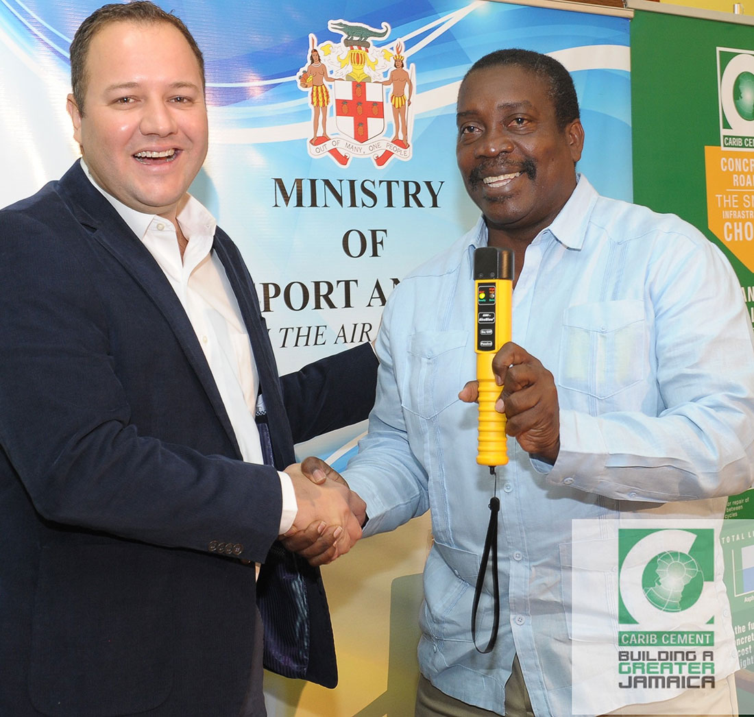 Peter Donkersloot, Carib Cement’s General Manager presents a breathalyzer to the Hon. Robert Montague, Minister of Transport and Mining